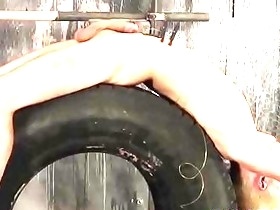 Roped to a tire sub slave cums while being wanked by master